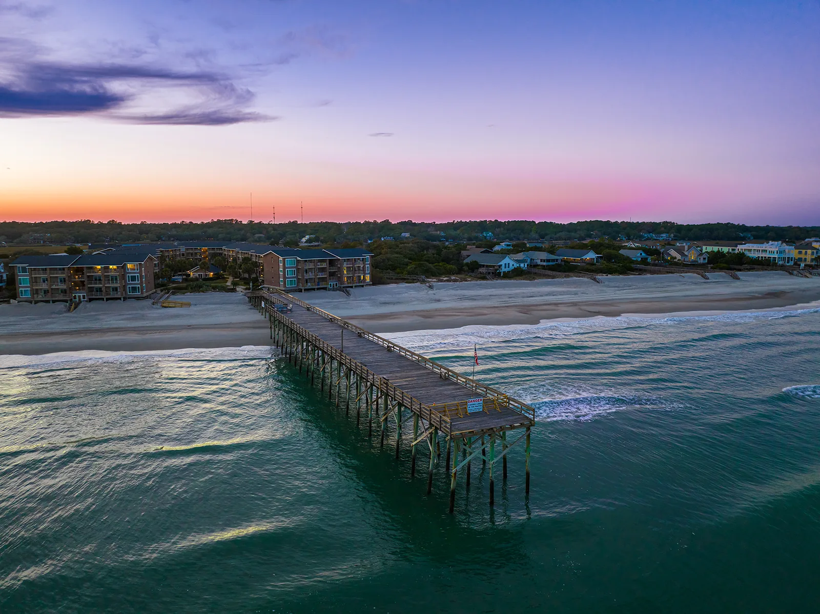 Pawleys Island pier reaching into the Atlantic at dusk, seen from above